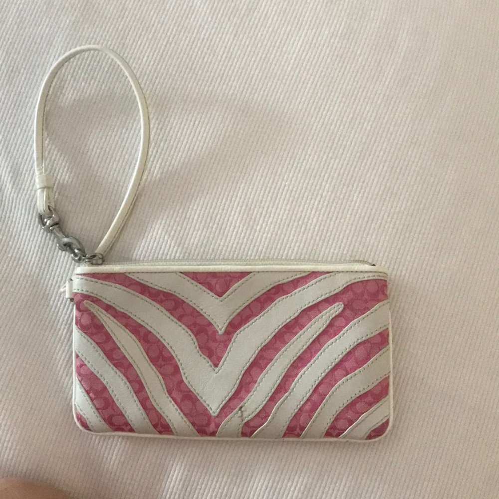 Pink and white coach wristlet.